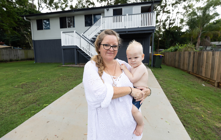 Tanika with her son outside their Kingston home, which was repurposed from the Logan railway realignment