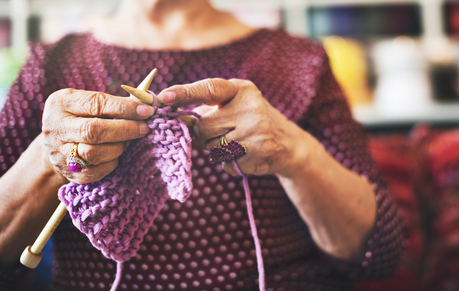 Val knitting using her hobby to form connections 