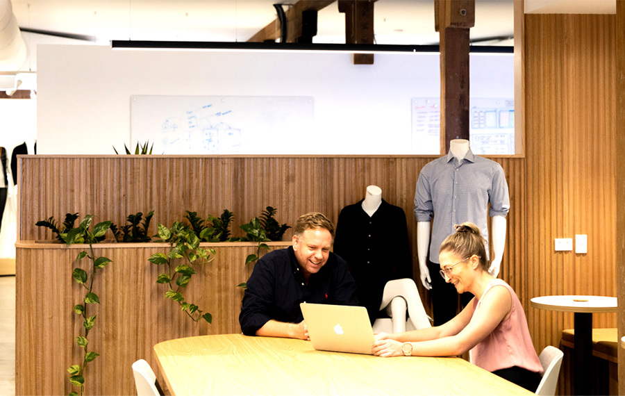 workers sitting at table in office