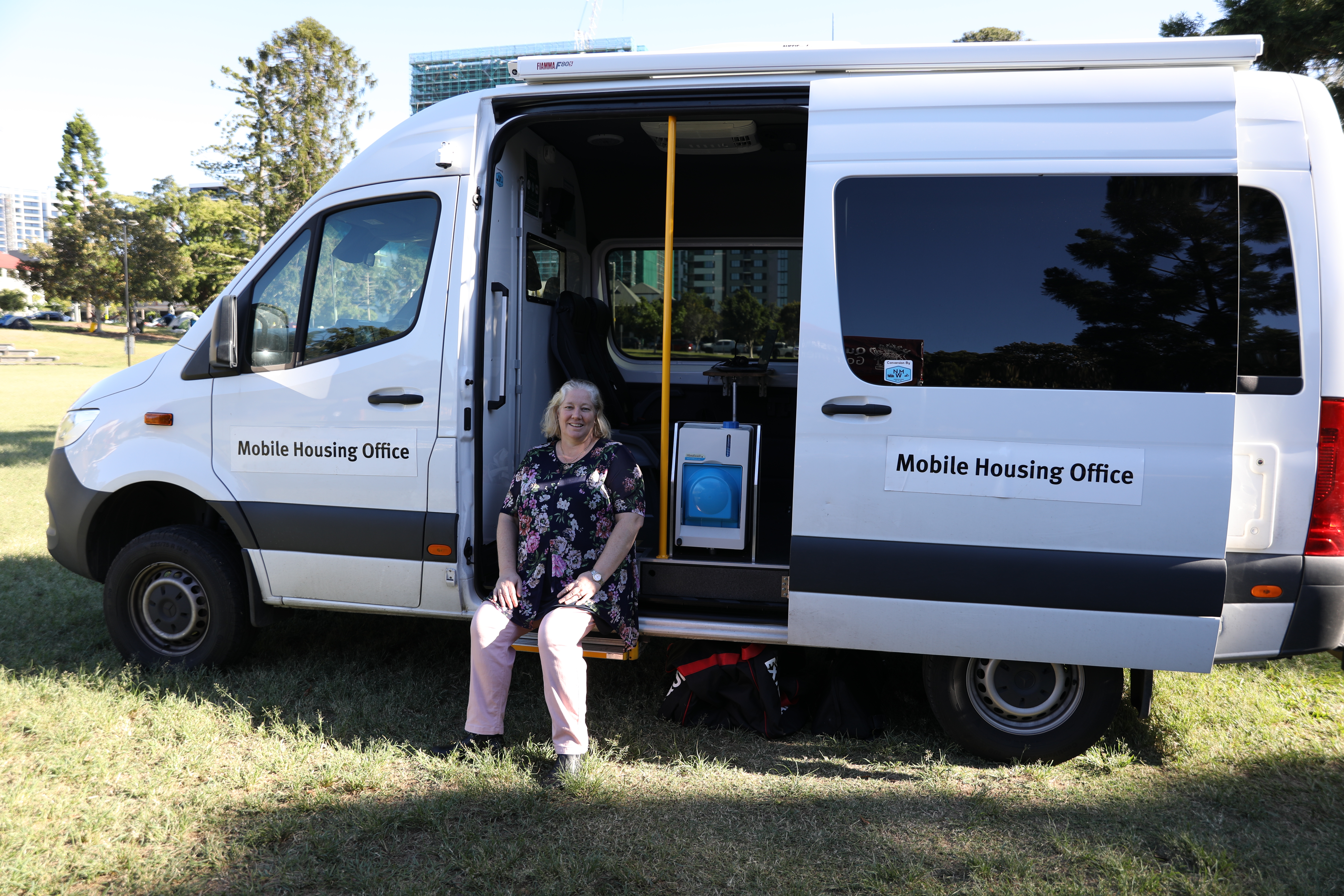 Worker sitting in door of critical response housing van